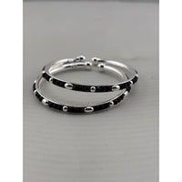 Load image into Gallery viewer, 925 sterling silver kids bangle pair close-up showing black bead and silver accent pattern
