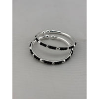 Load image into Gallery viewer, 925 sterling silver kids bangle pair stacked view showing black bead and silver accent design

