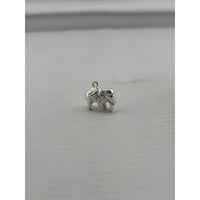 Load image into Gallery viewer, Original three-quarter view of a silver standing elephant pendant with curled trunk
