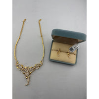 Load image into Gallery viewer, Gold-plated layered leaf necklace with matching clear-stone drop earrings
