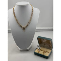 Load image into Gallery viewer, Gold-plated crystal floral necklace and matching earrings on jewellery display
