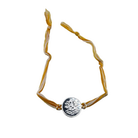 Load image into Gallery viewer, Lotus Charm Rakhi Bracelet – Adjustable Sacred Thread Rakhi with Lotus Engraved Metal Charm
